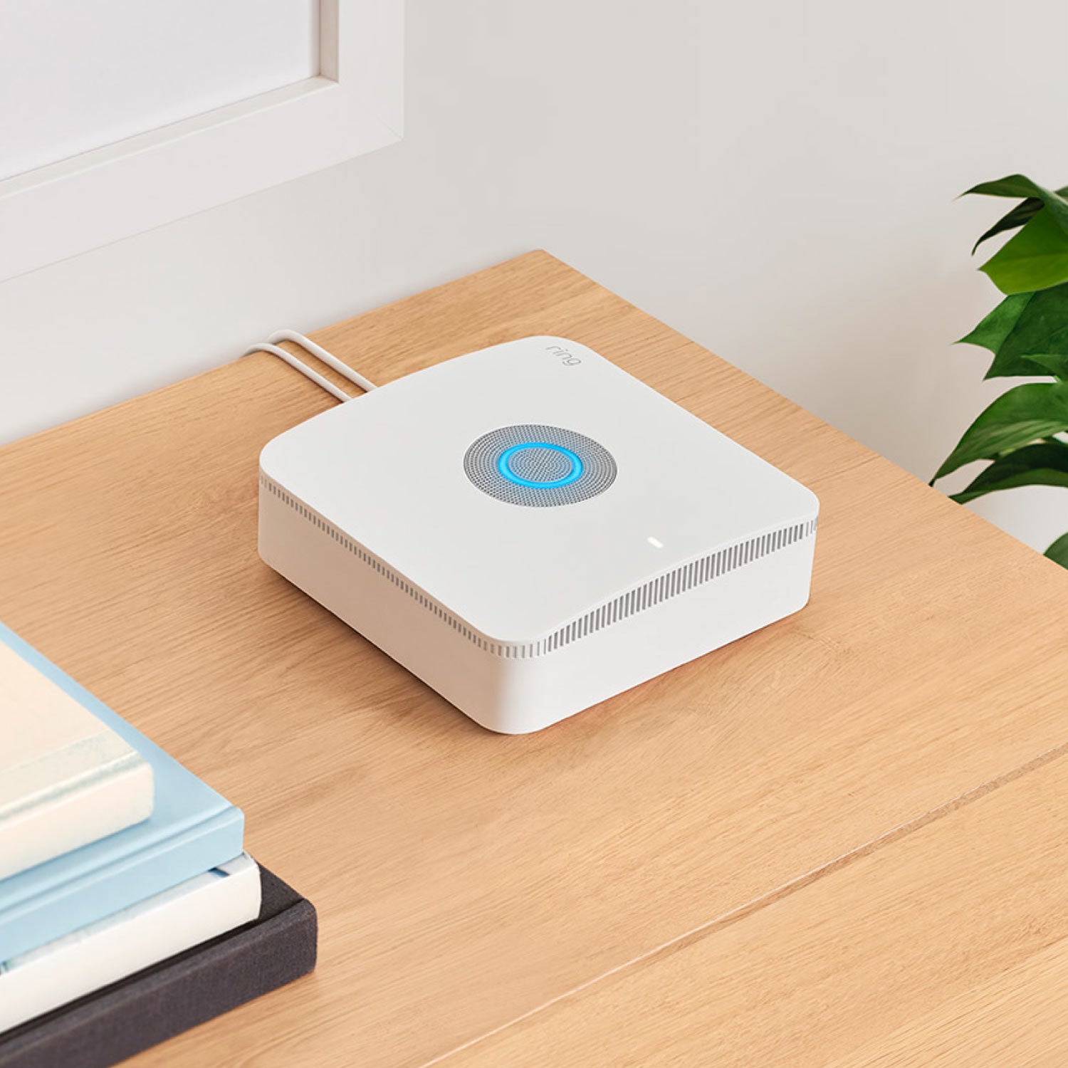 Alarm Pro Security Kit, 8-Piece (with built-in eero Wi-Fi 6 router) - Ring Alarm Pro Base Station with glowing blue light and power cables extending from the back.