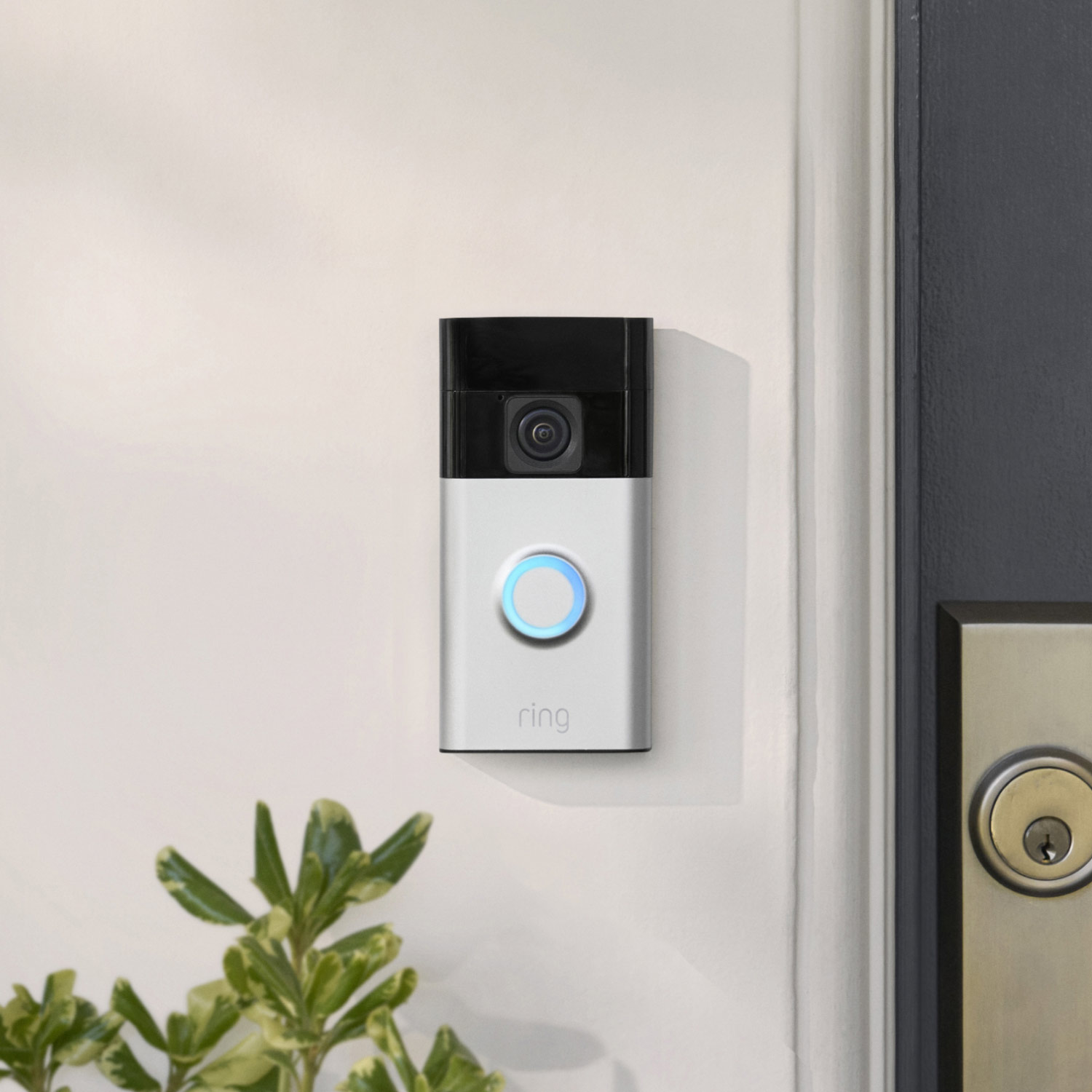 No-Drill Mount for Battery Doorbells (for Video Doorbell 3, Video Doorbell 3 Plus, Video Doorbell 4, Battery Doorbell, Battery Doorbell Plus, Battery Doorbell Pro) - Ring Battery Doorbell with satin nickel faceplate and an blue-lit button mounted next to a front door.