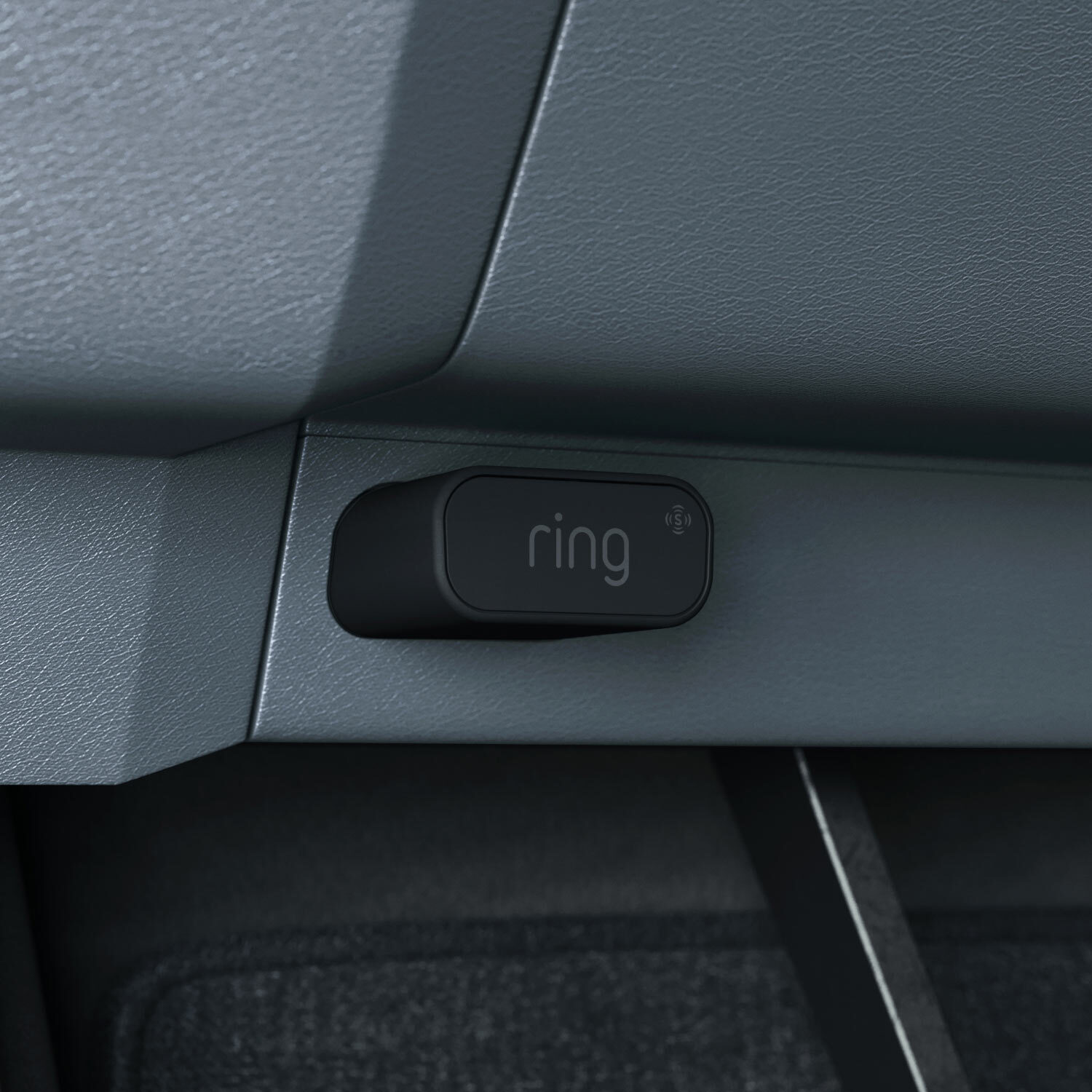 Car Alarm - Black rectangular Car Alarm plugged into OBD 2 port inside car.