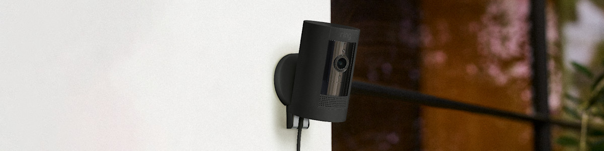 Black Ring security camera mounted on white wall