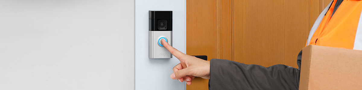 Delivery person pressing Ring Video Doorbell at front door