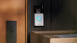 Ring Video Doorbell mounted on wooden door frame with parcels below